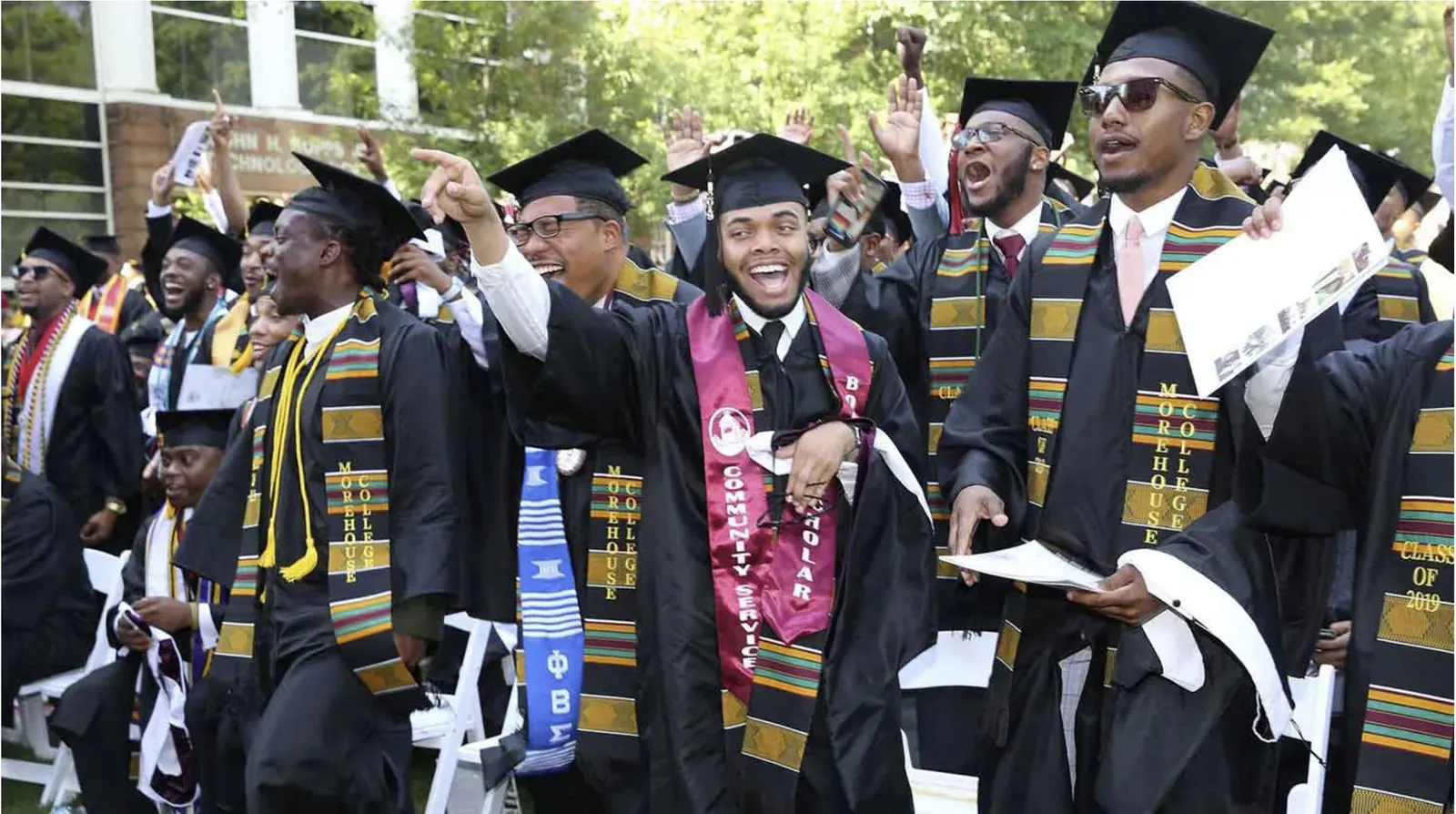 Graduates in caps and gowns celebrating at a graduation ceremony