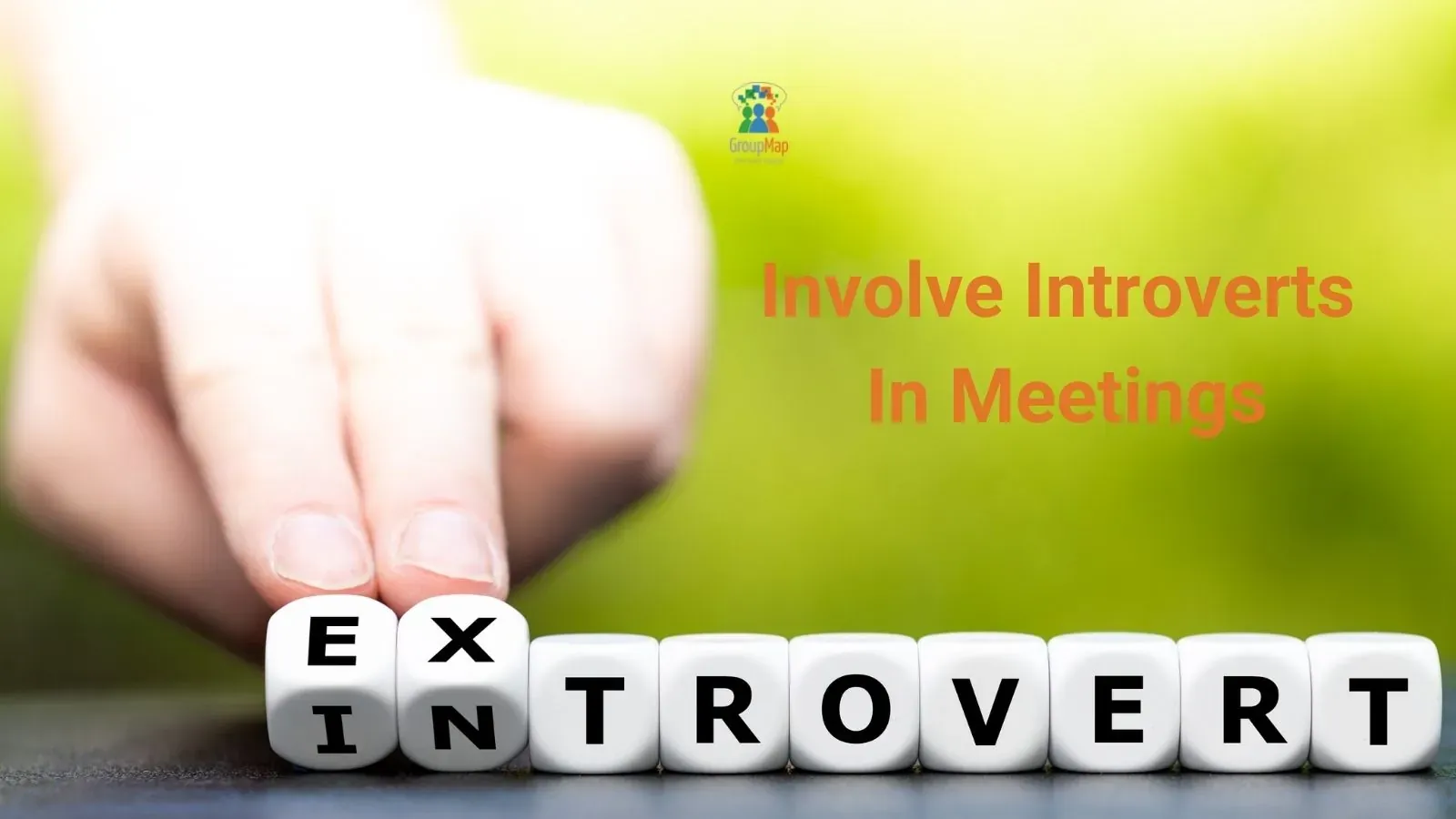 Hand turning lettered dice to change the word extrovert to introvert