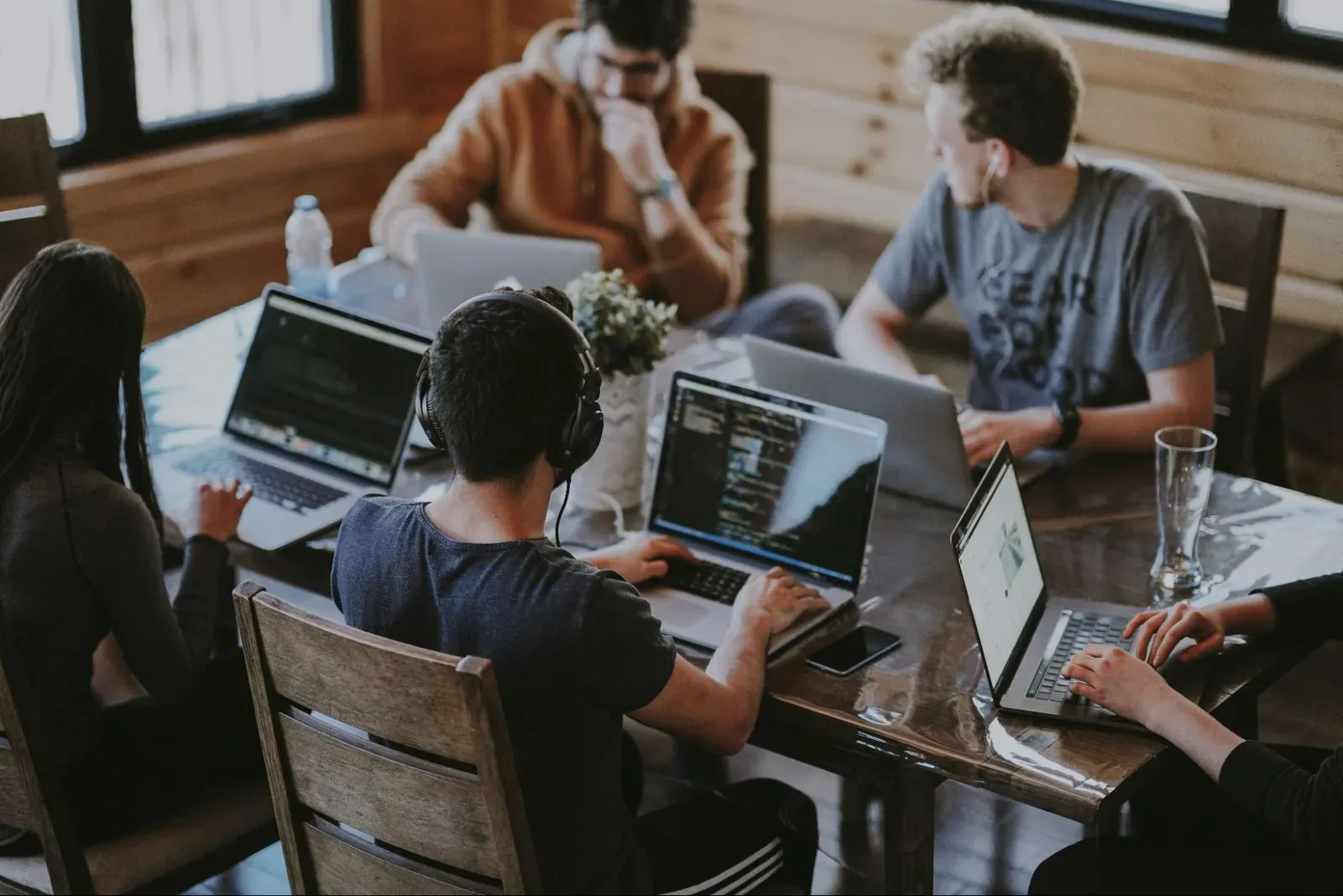 Team working together on laptops around a table