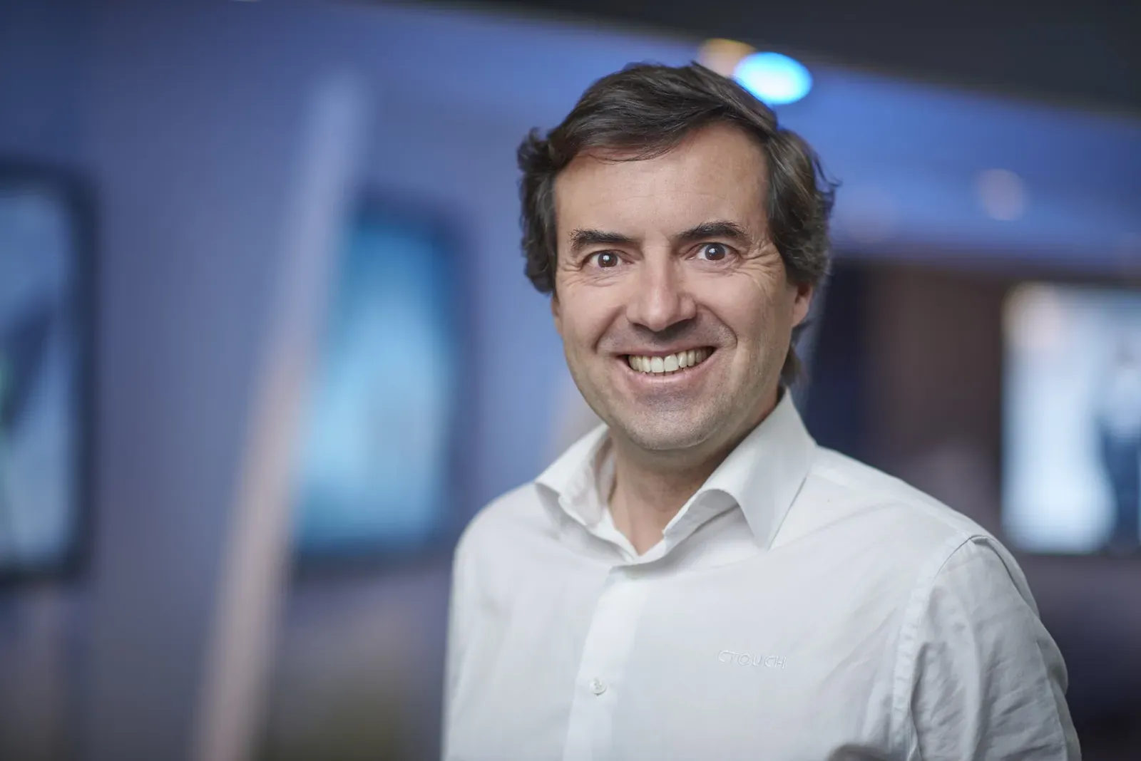 Portrait of a smiling facilitator in a white shirt