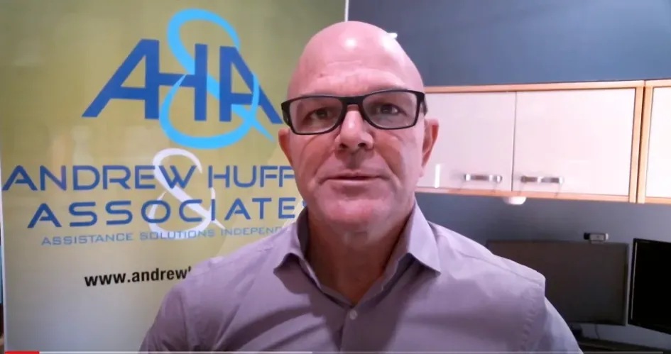 Facilitator speaking to camera in front of an Andrew Huffer and Associates banner